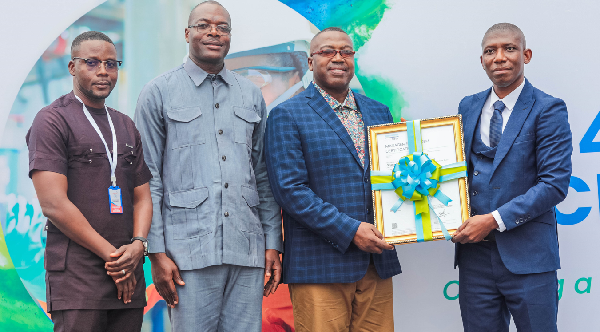 The Chief Executive Officer of Ghana National Gas Company, Dr Ben Asante (left) receiving the certification from Mr Emmanuel Siaw, a representative of DNV, the certifying body. Standing by Dr Asante are Mr Robert Lartey, the General Manager, Operations and Project Co-ordinator, Mr Jaasu Yahaya. 